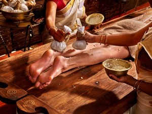 Young woman having feet Ayurveda India spa massage.